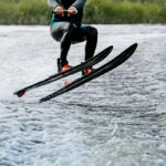 Man waterskiing on lake behind
